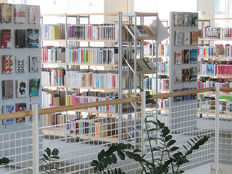 Übersicht einer Etage mit dicht bestückten Regalen in heller Umgebung.